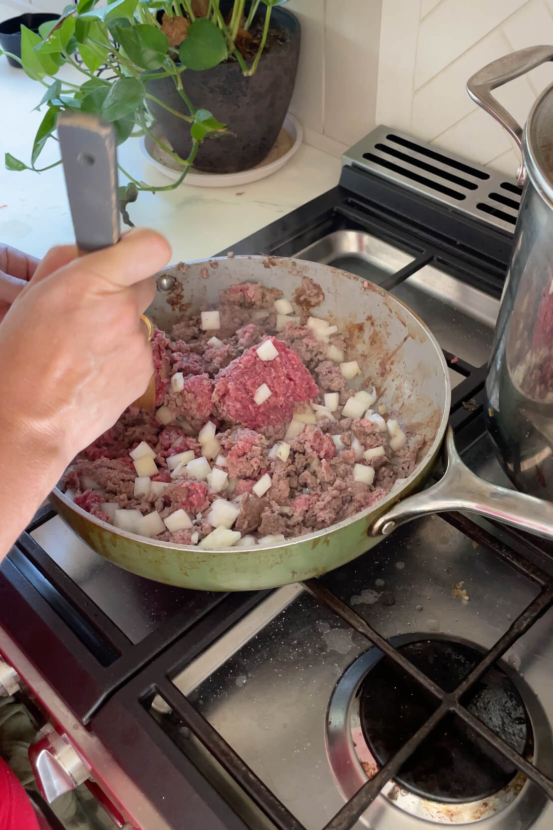 Cooking ground beef with onions for a classic chili recipe.